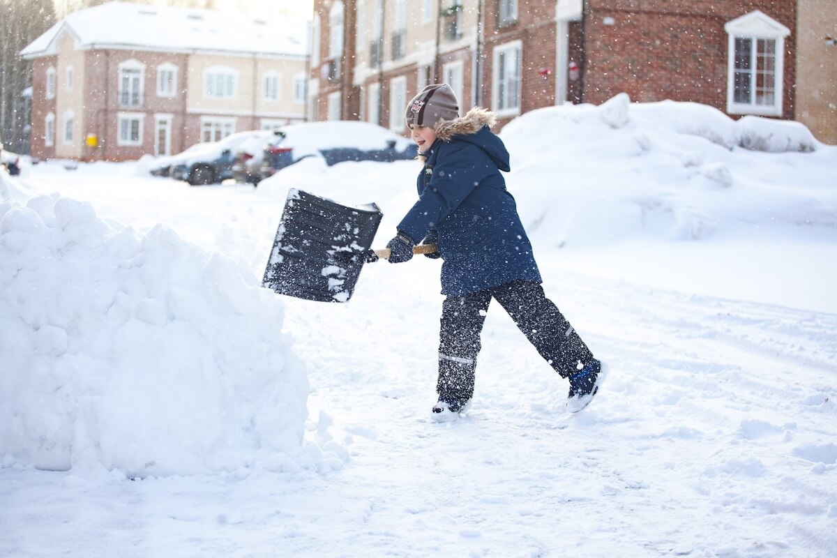 kid earning money shoveling snow